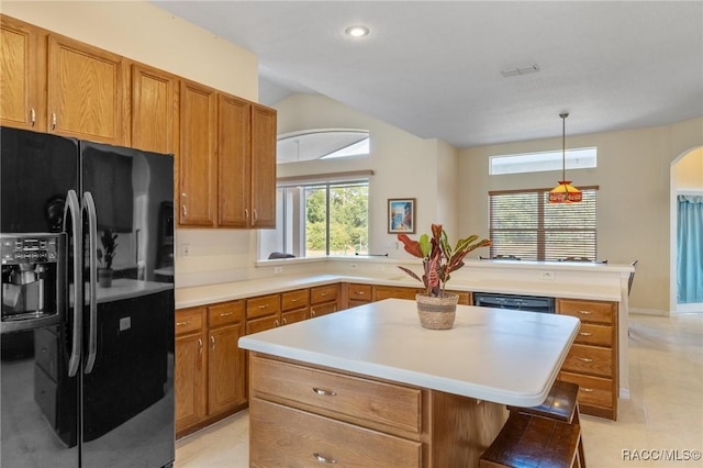 kitchen with a kitchen breakfast bar, black appliances, light tile patterned floors, a kitchen island, and hanging light fixtures