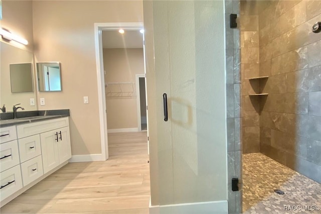 786 E Dunbar Ln, Hernando, FL 34442 - bathroom featuring double vanity, a stall shower, wood finished floors, and a spacious closet