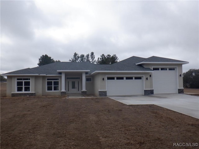 view of front of house with a garage and central AC