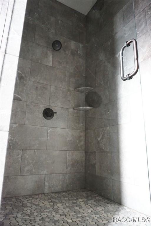 bathroom with a tile shower