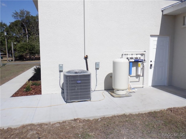 details featuring central air condition unit and stucco siding