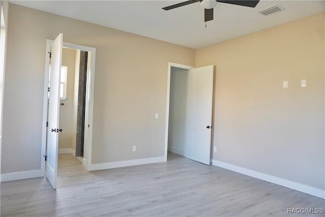 unfurnished bedroom with visible vents, baseboards, light wood-style floors, and a ceiling fan