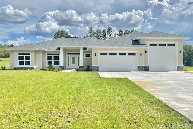 786 E Dunbar Ln, Hernando, FL 34442 - prairie-style home featuring a garage, stone siding, stucco siding, a front yard, and concrete driveway
