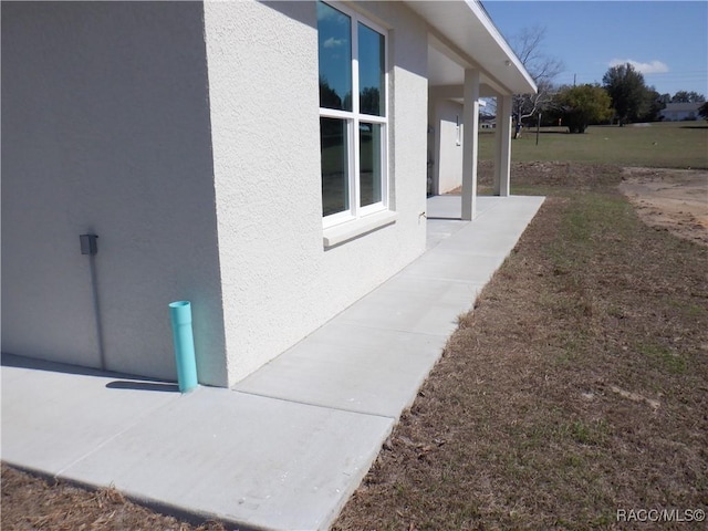 view of side of property featuring stucco siding