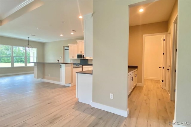 786 E Dunbar Ln, Hernando, FL 34442 - kitchen featuring stainless steel microwave, dark countertops, light wood-style flooring, white cabinets, and recessed lighting