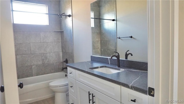 bathroom featuring vanity, toilet, and tub / shower combination