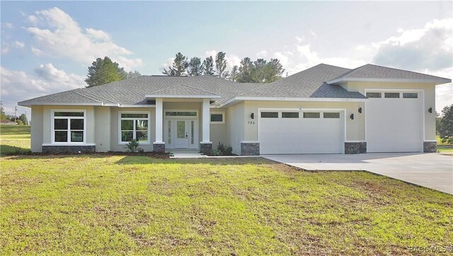 prairie-style home featuring stone siding, concrete driveway, a front yard, a garage, and central AC unit