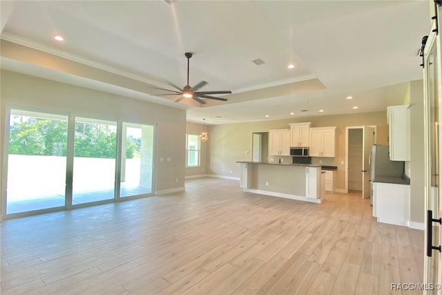 786 E Dunbar Ln, Hernando, FL 34442 - unfurnished living room with a tray ceiling, ceiling fan, light wood-style flooring, recessed lighting, and ornamental molding