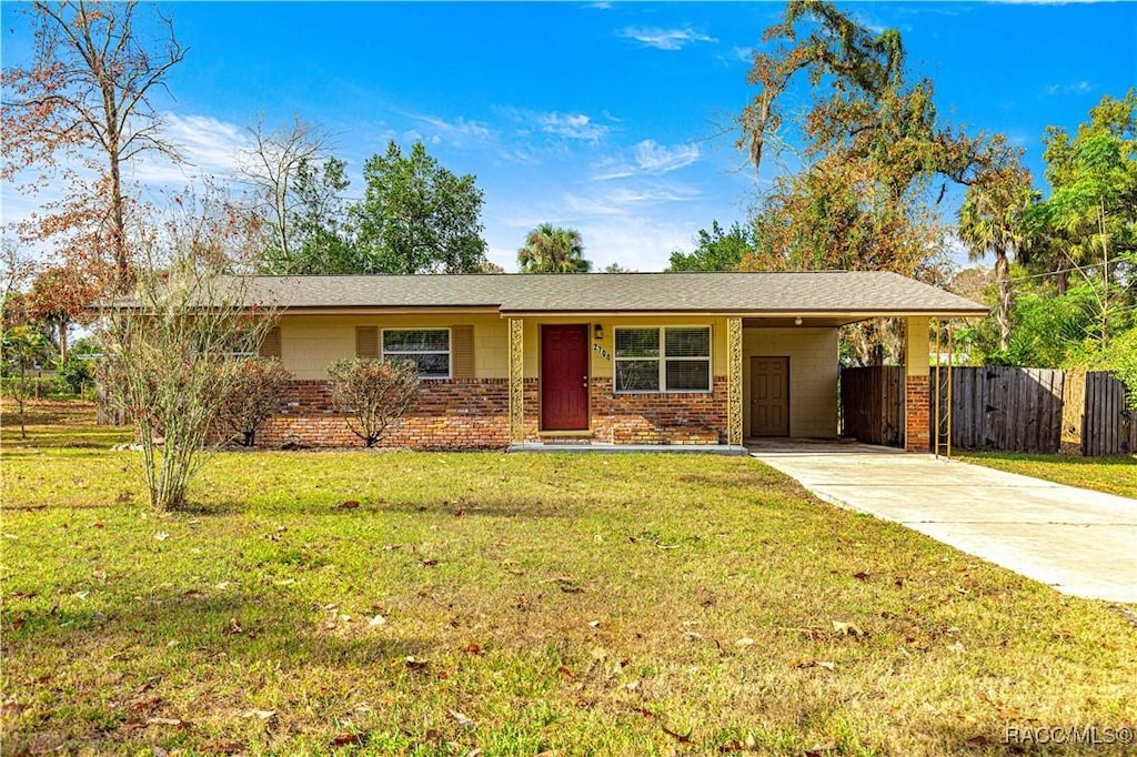 single story home with a front lawn and a carport