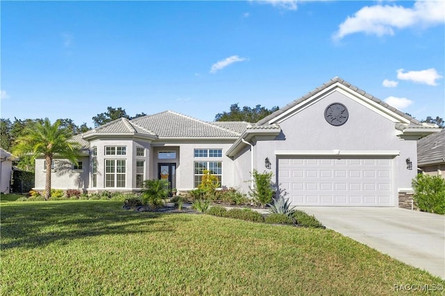 view of front of property featuring a garage and a front lawn