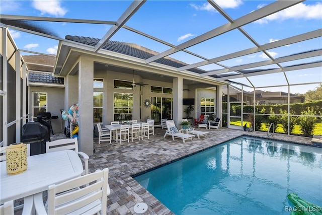 view of pool featuring a lanai, a patio area, and ceiling fan