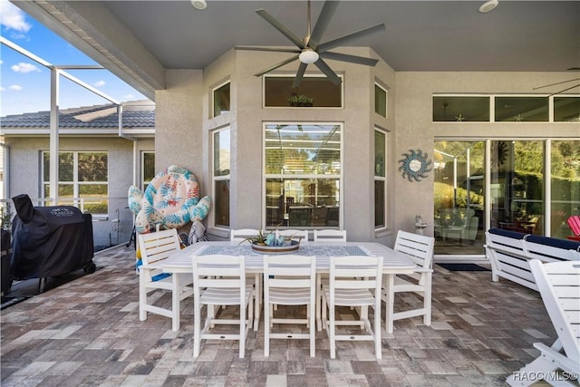 view of patio / terrace with a lanai, grilling area, and ceiling fan