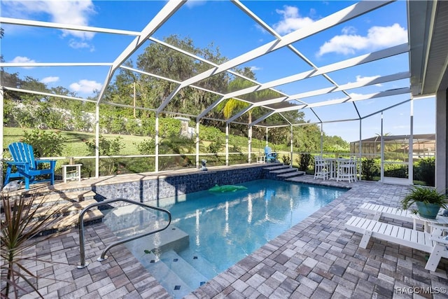 view of swimming pool featuring a patio and glass enclosure