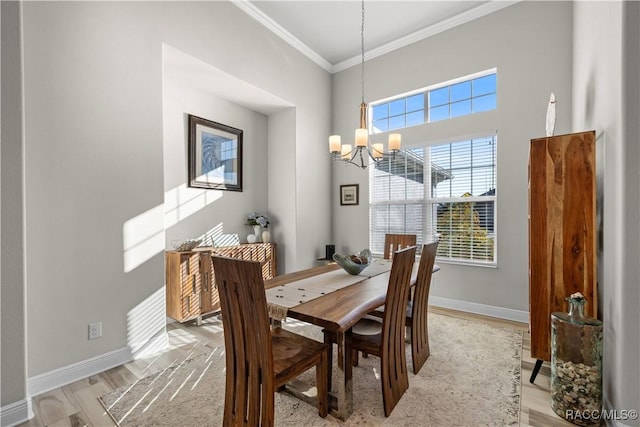 dining area featuring a chandelier, ornamental molding, and light wood-type flooring