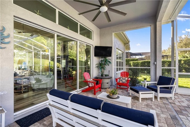 sunroom featuring ceiling fan and a wealth of natural light