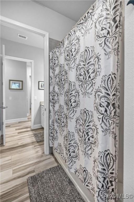 bathroom with vanity and wood-type flooring