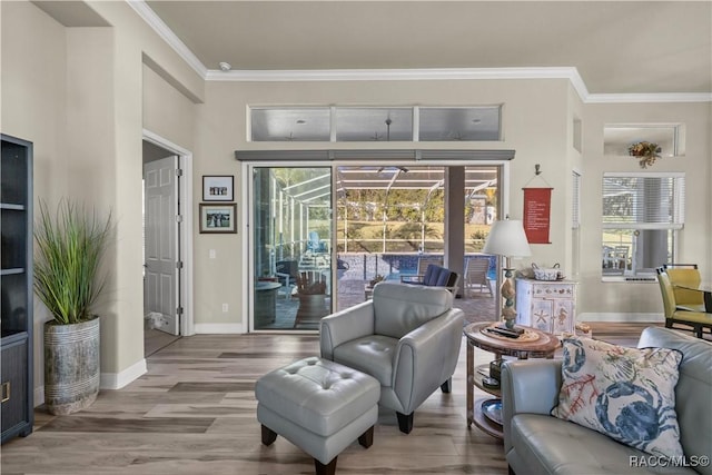 living area with hardwood / wood-style floors and crown molding