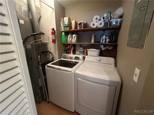 18 56th St, Yankeetown, FL 34498 - laundry room featuring separate washer and dryer, electric panel, a textured ceiling, and light wood finished floors