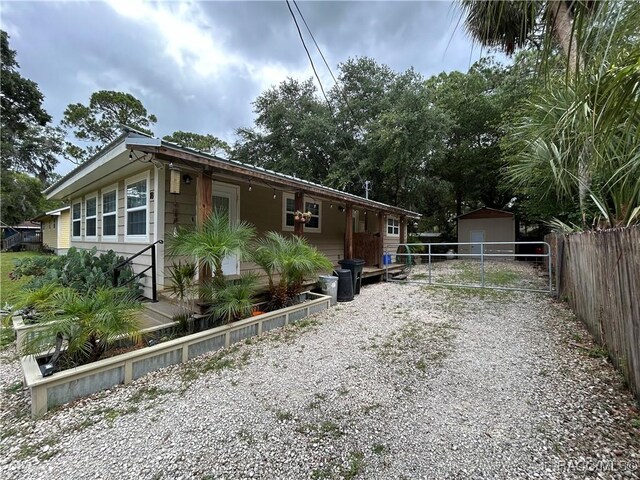 18 56th St, Yankeetown, FL 34498 - view of side of home featuring gravel driveway and an outdoor structure