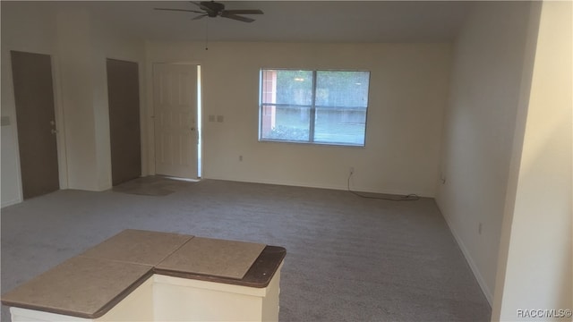 carpeted empty room with ceiling fan