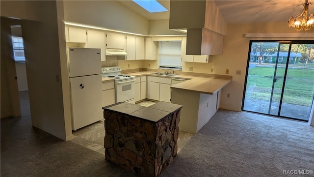 kitchen with light carpet, white appliances, vaulted ceiling with skylight, white cabinets, and under cabinet range hood