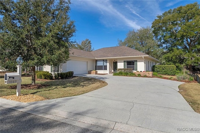 single story home featuring a garage and a front lawn