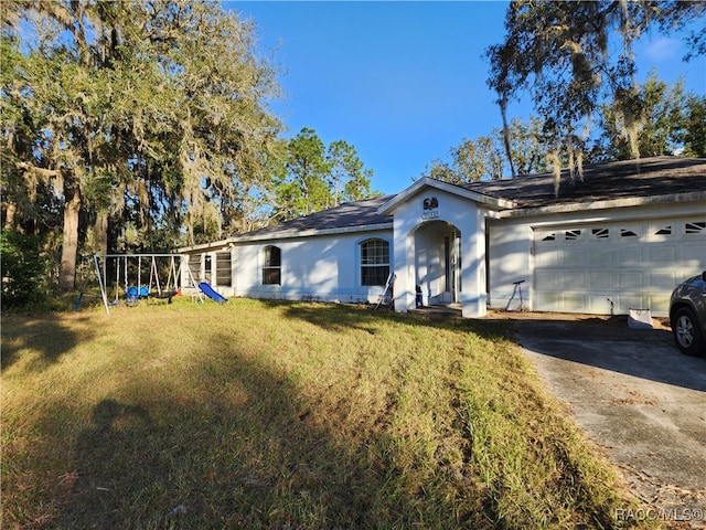 ranch-style house featuring a front yard and a garage