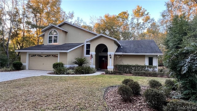 front facade with a garage and a front lawn