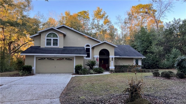 front facade featuring a garage and a front lawn