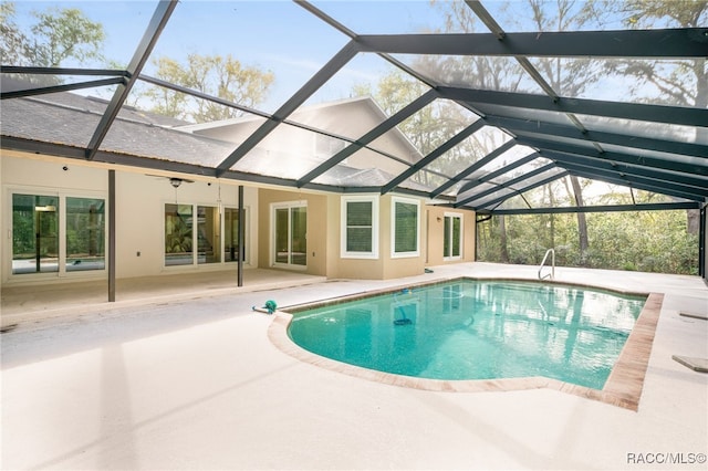 outdoor pool with a lanai and a patio