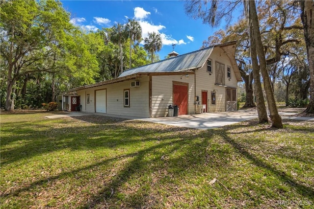 rear view of property featuring metal roof, a yard, a chimney, and a wall mounted air conditioner