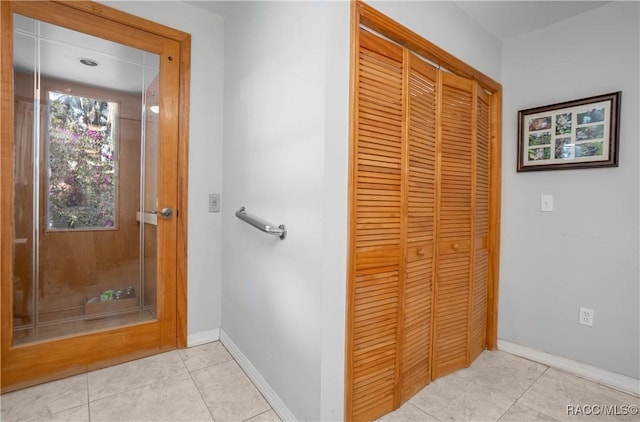 bathroom with tile patterned flooring and baseboards