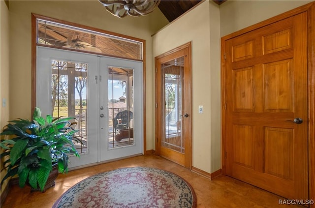 foyer entrance featuring baseboards and french doors