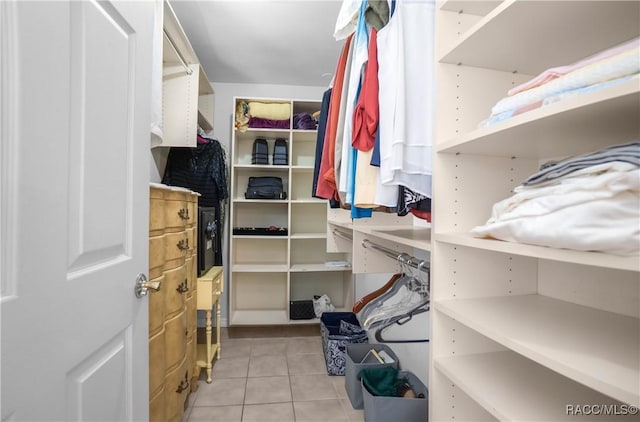 spacious closet with light tile patterned floors