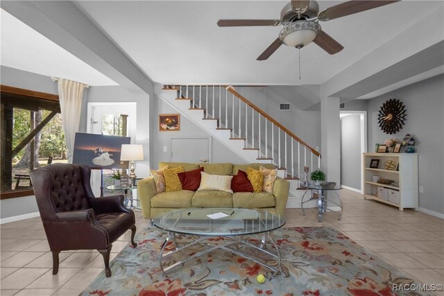 living room with tile patterned flooring, stairs, visible vents, and baseboards