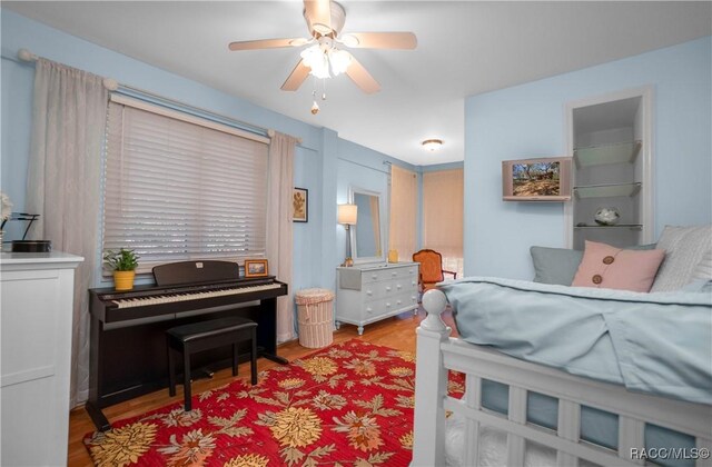 bedroom featuring a ceiling fan and light wood-style flooring