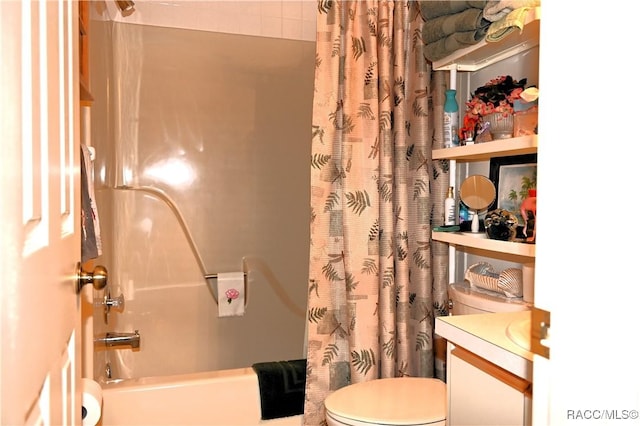 full bathroom with shower / bath combo with shower curtain, vanity, and toilet