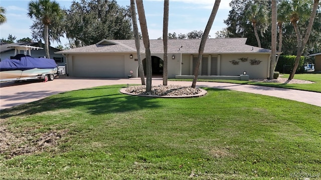 ranch-style house with a front yard and a garage