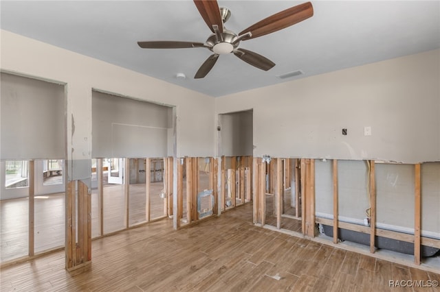 unfurnished room with ceiling fan and light wood-type flooring