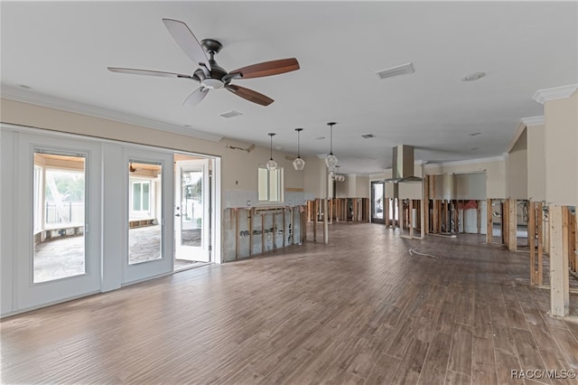 unfurnished living room with ceiling fan, dark hardwood / wood-style flooring, and crown molding