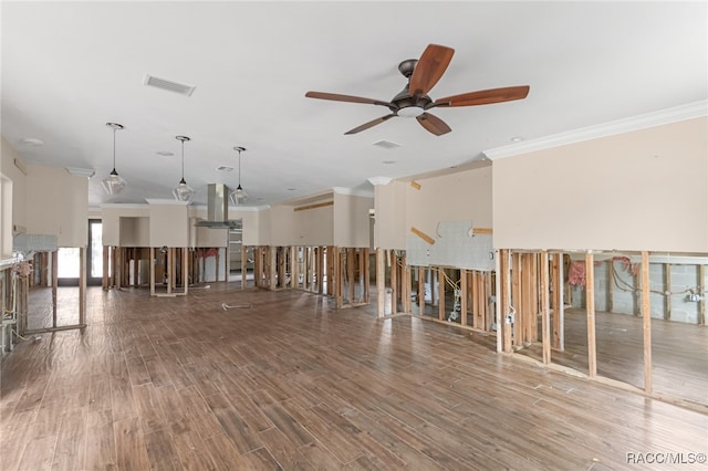 spare room with crown molding, ceiling fan, and wood-type flooring