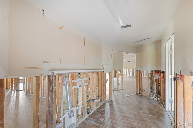 hallway with hardwood / wood-style flooring and a healthy amount of sunlight