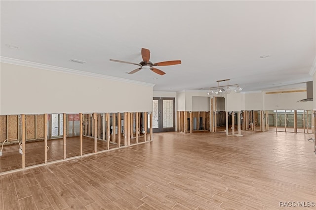 unfurnished room with ornamental molding, light hardwood / wood-style floors, and a healthy amount of sunlight