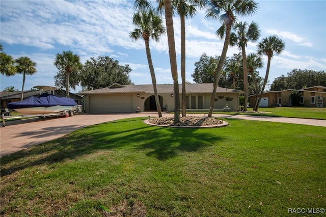 ranch-style home featuring a garage and a front yard