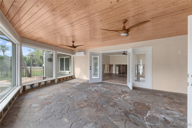 unfurnished sunroom featuring french doors, a wall mounted AC, and wood ceiling