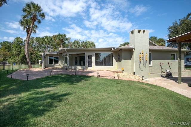 rear view of property with a patio area and a yard