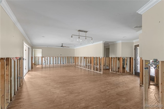 corridor with wood-type flooring and ornamental molding