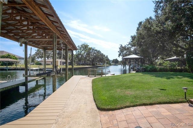 dock area with a yard and a water view