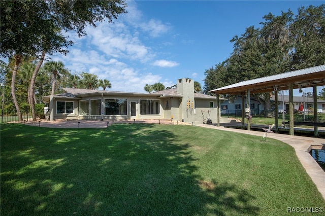 back of house featuring a lawn