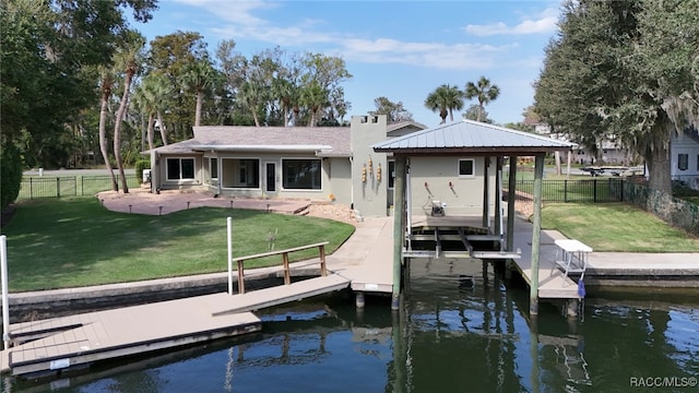 dock area with a lawn, a water view, and a patio